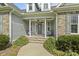 Inviting covered porch with stone steps and seating area, perfect for relaxing outdoors at 21 Boots Dr, Angier, NC 27501