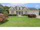 Charming home with manicured lawn and stone accents, creating inviting curb appeal at 21 Boots Dr, Angier, NC 27501