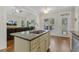 Kitchen featuring an island, access to the living room, and a door to the backyard at 21 Boots Dr, Angier, NC 27501