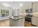 Kitchen featuring a center island, stainless appliances, and access to the backyard at 21 Boots Dr, Angier, NC 27501
