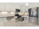 Modern kitchen features granite countertops, stainless steel appliances, and ample cabinet space at 21 Boots Dr, Angier, NC 27501