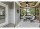 Inviting screened porch with ceiling fan, neutral decor, and outdoor furniture at 21 Boots Dr, Angier, NC 27501