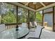 Inviting screened porch with ceiling fan, neutral decor, and outdoor furniture at 21 Boots Dr, Angier, NC 27501