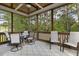 Inviting screened porch with ceiling fan, neutral decor, and outdoor furniture at 21 Boots Dr, Angier, NC 27501
