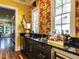 Well-equipped bar area featuring custom cabinetry, a countertop, and stylish wallpaper at 2125 Pine Dr, Raleigh, NC 27608