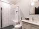 Modern bathroom with a white tiled shower, glass door, and a stylish vanity at 2125 Pine Dr, Raleigh, NC 27608