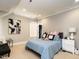 Bedroom with neutral tones, patterned bedding, and carpet floors at 2125 Pine Dr, Raleigh, NC 27608