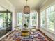 Bright breakfast nook with a glass top table, yellow chairs, and large windows at 2125 Pine Dr, Raleigh, NC 27608
