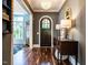 Welcoming foyer featuring hardwood floors, elegant lighting, and a glimpse of the dining room at 2125 Pine Dr, Raleigh, NC 27608