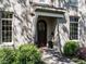 Close up of the front door, framed by manicured shrubbery and a stylish portico at 2125 Pine Dr, Raleigh, NC 27608