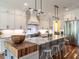 Modern kitchen boasts a large island with seating, stainless appliances, and ample cabinet space at 2125 Pine Dr, Raleigh, NC 27608