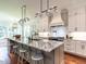 Gourmet kitchen with an island that has a marble countertop, pendant lighting, and stainless steel appliances at 2125 Pine Dr, Raleigh, NC 27608