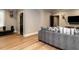 Cozy living room with wood floors, a comfortable sofa, and a wall-mounted television at 2125 Pine Dr, Raleigh, NC 27608