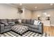 Inviting living room featuring a large gray sectional sofa, patterned ottoman, and stylish decor at 2125 Pine Dr, Raleigh, NC 27608