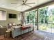 Relaxing covered porch with comfortable seating, a ceiling fan, and a view of the wooded backyard at 2125 Pine Dr, Raleigh, NC 27608