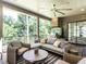 Inviting porch with wicker seating, a ceiling fan, and a dining area overlooking the lush backyard at 2125 Pine Dr, Raleigh, NC 27608