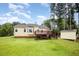 Backyard featuring a large lawn, wooden deck, and home exterior providing a great outdoor space at 220 Needle Park Dr, Cary, NC 27513