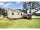 Exterior showcasing a well-maintained lawn, wooden deck, and charming home exterior at 220 Needle Park Dr, Cary, NC 27513