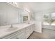 Bright bathroom features dual sinks, white cabinets, and great natural light at 220 Needle Park Dr, Cary, NC 27513