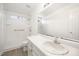 Bright bathroom featuring a walk-in shower, a vanity with sink, and updated fixtures at 220 Needle Park Dr, Cary, NC 27513