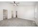 Large bedroom with gray carpet, ceiling fan, and natural lighting at 220 Needle Park Dr, Cary, NC 27513