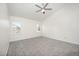 Bright bedroom with gray carpet, ceiling fan, and two windows at 220 Needle Park Dr, Cary, NC 27513