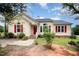 Charming single-Gathering home with a red front door and beautiful landscaped yard at 220 Needle Park Dr, Cary, NC 27513