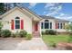Charming single-Gathering home with a red front door and beautiful landscaped yard at 220 Needle Park Dr, Cary, NC 27513