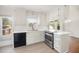Updated kitchen features stainless steel appliances, white cabinets, and quartz countertop at 220 Needle Park Dr, Cary, NC 27513
