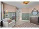 Stylish bedroom features a cozy chair, warm lighting, and a changing table at 222 Faith Avenue, Sanford, NC 27330