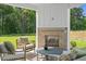 Inviting covered porch with fireplace and comfortable outdoor seating at 222 Faith Avenue, Sanford, NC 27330