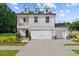 Charming two-story home boasts a welcoming front porch, attached garage, and beautifully landscaped yard at 222 Faith Avenue, Sanford, NC 27330