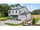 Charming two-story home with white siding, attached garage, and manicured front lawn at 222 Faith Avenue, Sanford, NC 27330