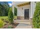 Inviting front porch with brick accents and manicured landscaping providing a warm welcome at 222 Faith Avenue, Sanford, NC 27330