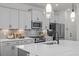 Modern kitchen features stainless steel appliances, quartz countertops, and ample cabinet space at 222 Faith Avenue, Sanford, NC 27330
