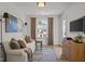 Cozy living room featuring a comfortable sofa, stylish decor, and plenty of natural light at 222 Faith Avenue, Sanford, NC 27330