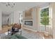Cozy living room features a modern fireplace, hardwood floors, and ample natural light at 222 Faith Avenue, Sanford, NC 27330