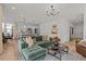 Open-concept living room with modern lighting, hardwood floors, and a green couch at 222 Faith Avenue, Sanford, NC 27330