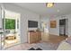 Bright living room with outside access, featuring a modern TV, stylish decor and light hardwood floors at 222 Faith Avenue, Sanford, NC 27330