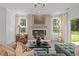 Stylish living room featuring a fireplace and large windows at 222 Faith Avenue, Sanford, NC 27330