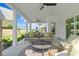Covered patio with outdoor seating features a ceiling fan and sliding glass door access to the home's interior at 223 Faith Avenue, Sanford, NC 27330