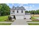 Beautiful two-story home boasts white siding, dormer windows, and a manicured lawn at 223 Faith Avenue, Sanford, NC 27330