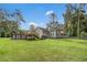 A beautiful backyard with a large grassy area, deck, and above-ground pool, perfect for outdoor entertaining at 229 White Oak Farm Dr, Willow Springs, NC 27592