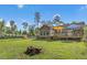 Large fenced backyard with lush lawn, wooden deck, and a fire pit at 229 White Oak Farm Dr, Willow Springs, NC 27592