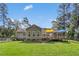 Charming home featuring a spacious deck, a well-maintained lawn, and mature trees in the backyard at 229 White Oak Farm Dr, Willow Springs, NC 27592