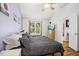 Bedroom with hardwood floors, ceiling fan, a TV, and a window providing ample natural light at 229 White Oak Farm Dr, Willow Springs, NC 27592