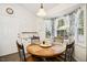 Charming breakfast nook featuring a round wooden table, four chairs, and natural light from a bay window at 229 White Oak Farm Dr, Willow Springs, NC 27592