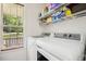 Bright laundry room with modern washer and dryer, storage shelves and natural light at 229 White Oak Farm Dr, Willow Springs, NC 27592