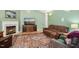 Comfortable living room with a cozy fireplace, hardwood flooring, and a plush brown sofa at 229 White Oak Farm Dr, Willow Springs, NC 27592