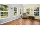 Living room with hardwood floors, large windows, and a comfortable recliner at 229 White Oak Farm Dr, Willow Springs, NC 27592